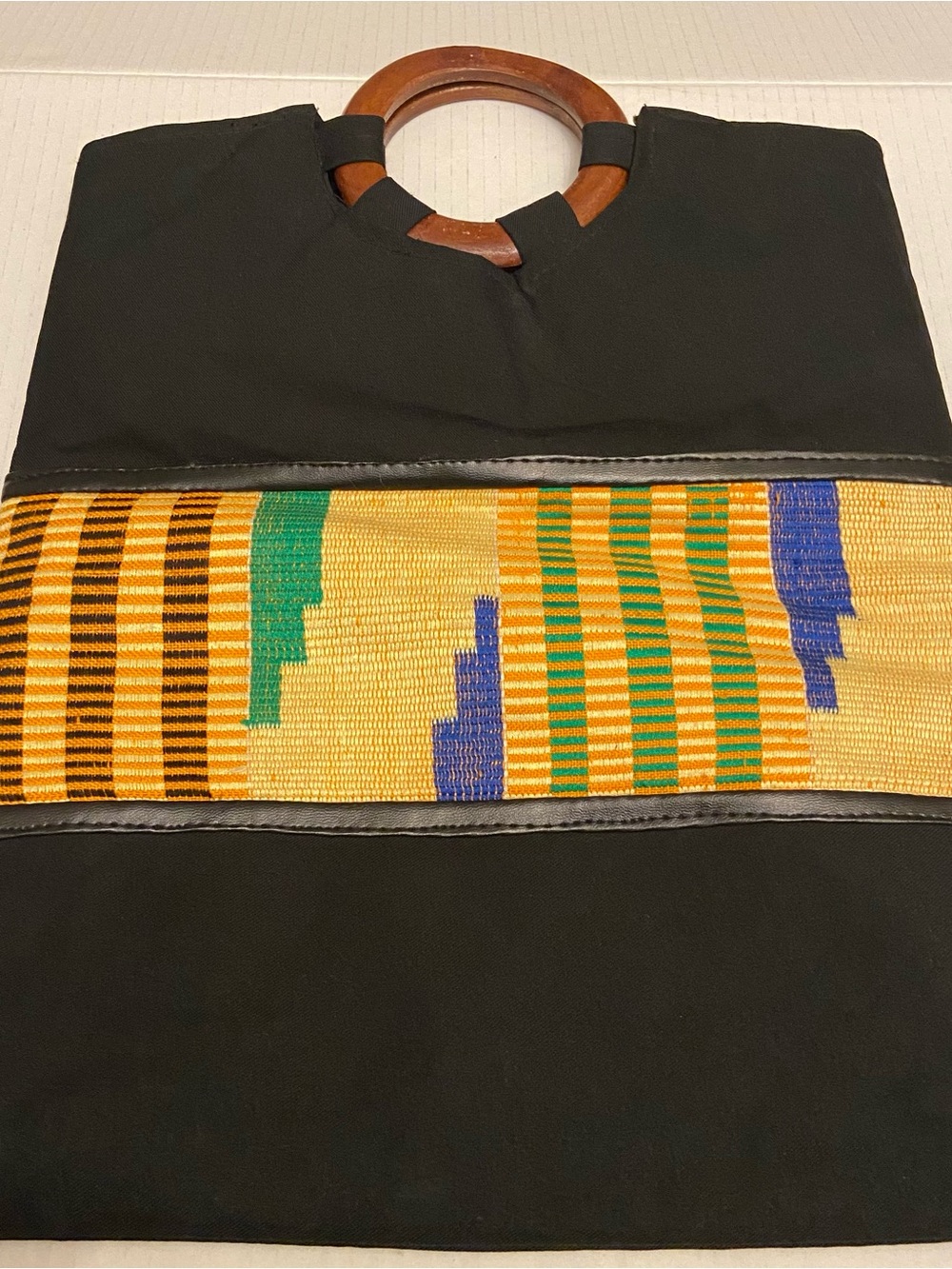 Women’s Black Tote Clutch Bag with Colorful Kente Stripe and Wooden Handles.